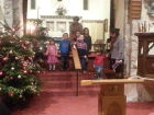 The children helping with assembling the nativity scene.